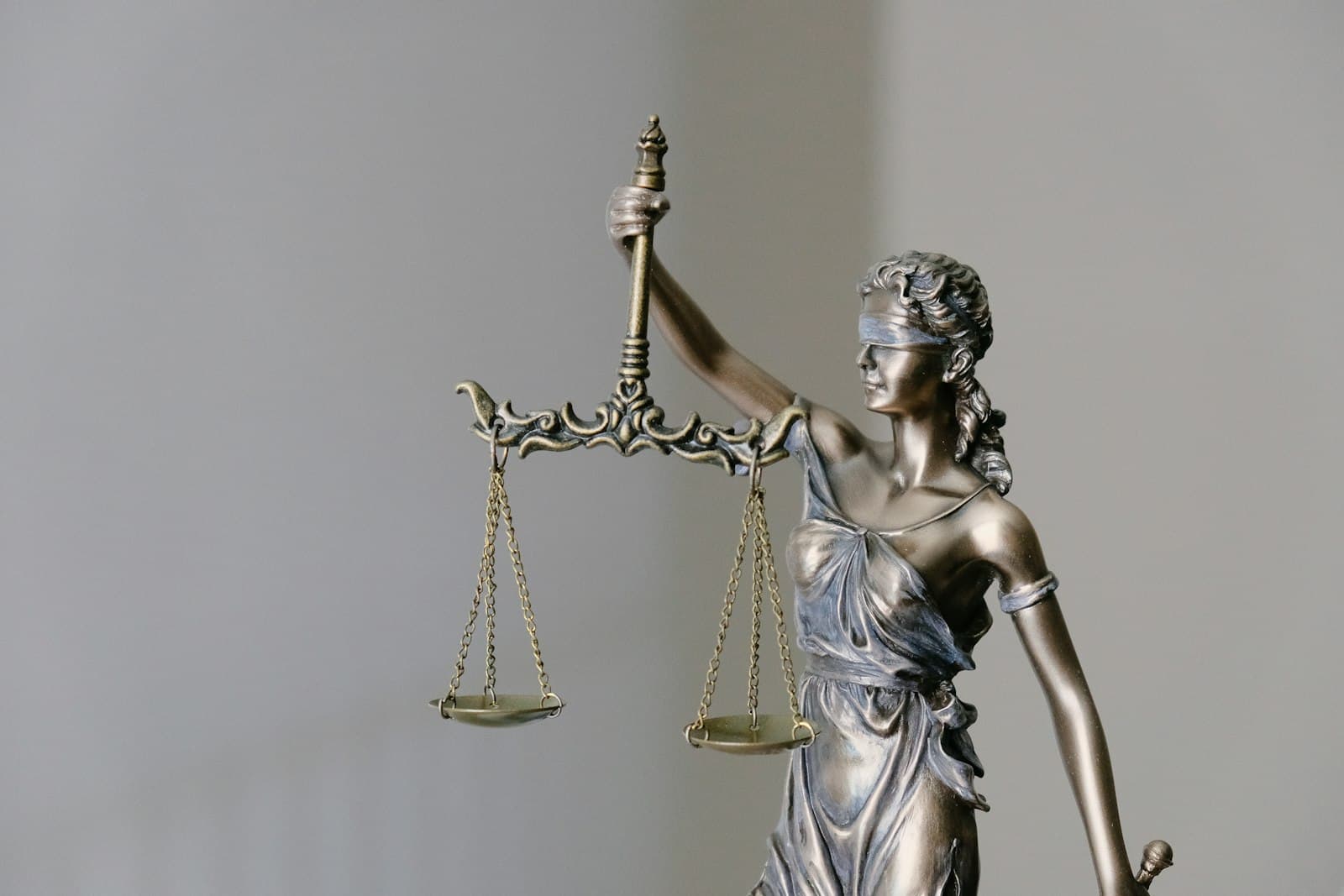 Statue de la justice tenant une balance et un glaive, symbole d'une décision de justice.